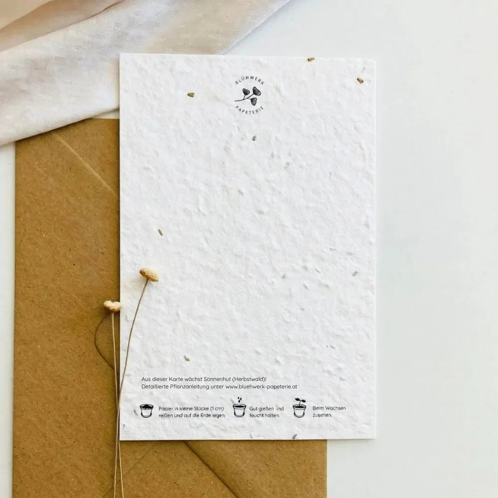 Grußkarte aus beigem Saatpapier mit Aufschrift „Dickes Bussi" und beiliegendem Kuvert.
