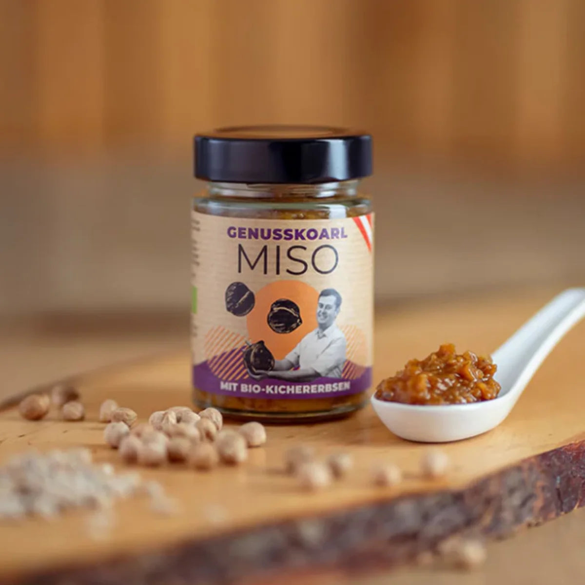 Ein Glas Kichererbsen Miso Bio mit braun-gelblichen, grobstückigen Paste und einem weißen Etikett.