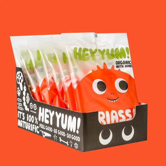 HEY YUM! Bio-Fruchtjoghurt-Gummibärchen in verschiedenen bunten Dinosaurierformen in einer geöffneten Packung.