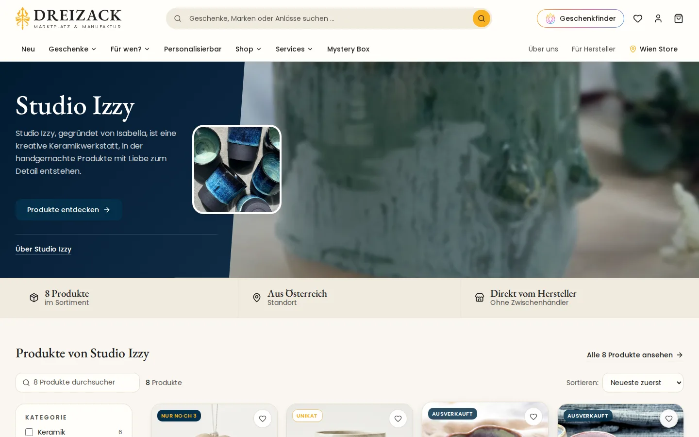 Herstellerseite von Studio Izzy im Shop: Name, kurzer Satz zur Marke, Logo mit blauen Keramikbechern, Knopf Produkte entdecken, darunter Zahl der Produkte, Herkunft Österreich und die Produktliste mit Filter