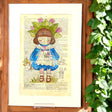 Original-Illustration von Book Fairy Art auf alter Buchseite mit Passepartout und optionalem Nussrahmen – nachhaltige Kunst aus Österreich
