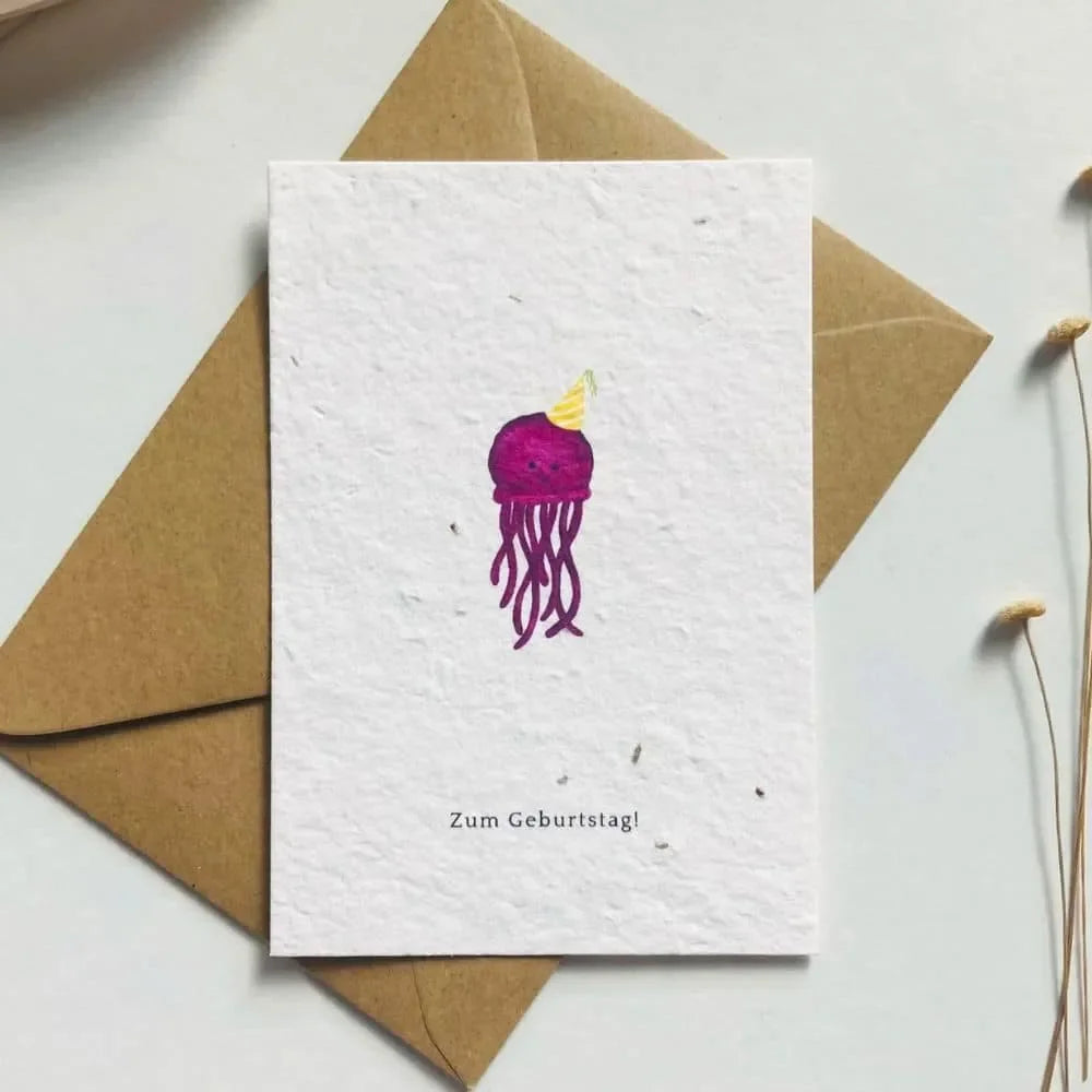 Geburtstagskarte aus einpflanzbarem Saatpapier mit handgemalter Qualle und Schriftzug Zum Geburtstag, beige-braune Papieroptik.