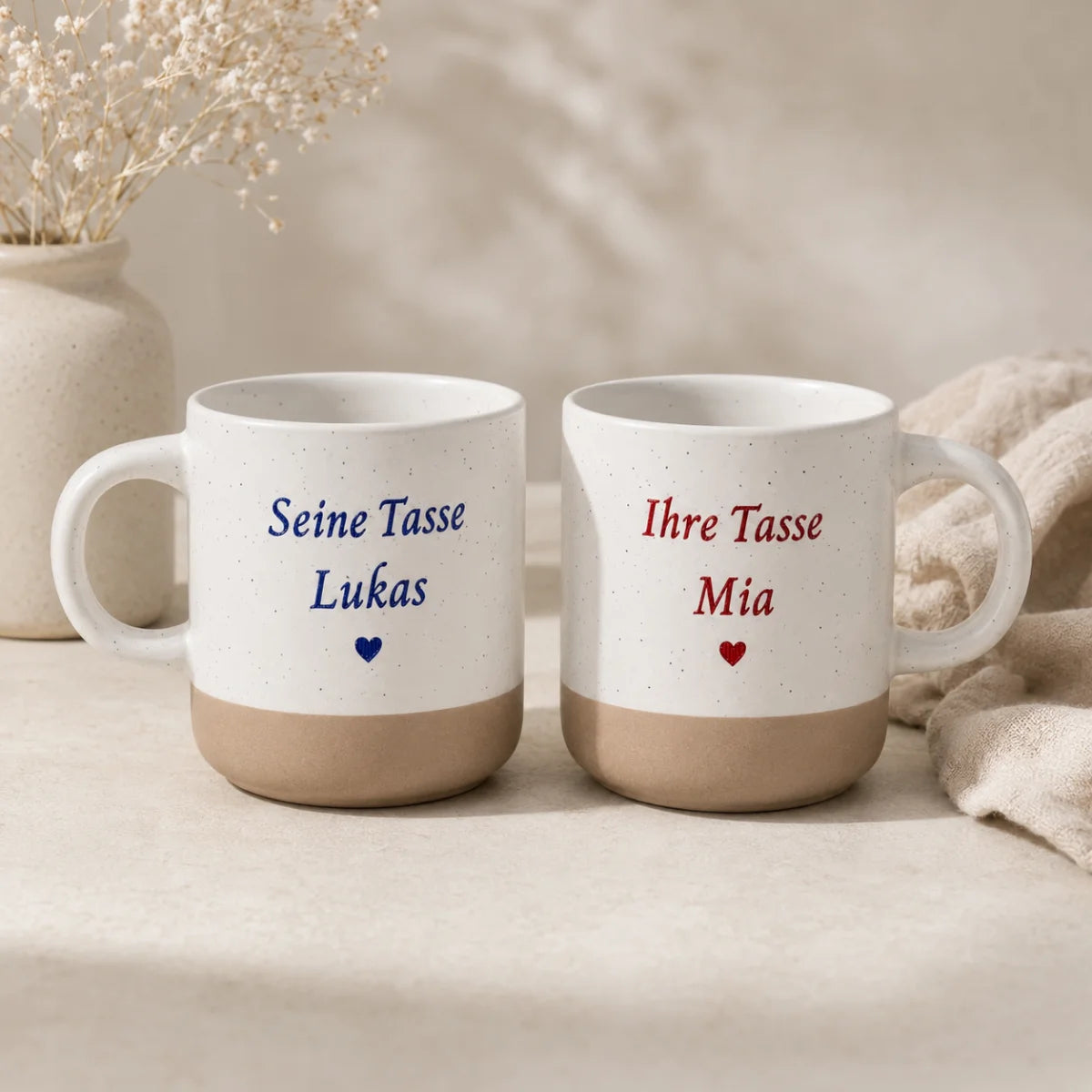 Weiß gesprenkelte Steingut Tasse mit farbig graviertem Wunschdesign und unglasiertem Boden.