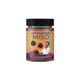 Ein Glas Kichererbsen Miso Bio mit braun-gelblichen, grobstückigen Paste und einem weißen Etikett.