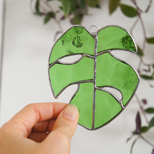 Monstera Blatt, Handgemachte Glasdeko von Magpie Castle, Tiffany-Technik, Naturmotive wie Monstera, Pilze & Blumen, zum Aufhängen oder als Pflanzenstecker, kunstvolle Glaskunst aus Österreich.