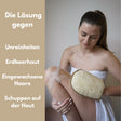 Ein rechteckiger Luffa Peelinghandschuh mit heller Baumwollseite und strukturierter Oberfläche aus Luffa-Fasern.
